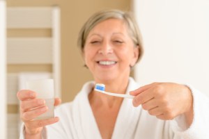 Scaling & Root Planing post op woman holding glass and brush