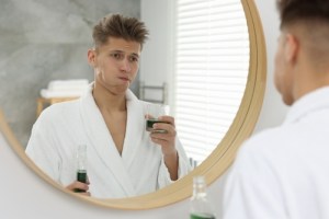 Man using mouthwash